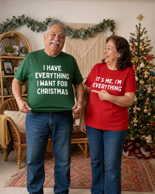 A man showing off the green tee while his wife laughs