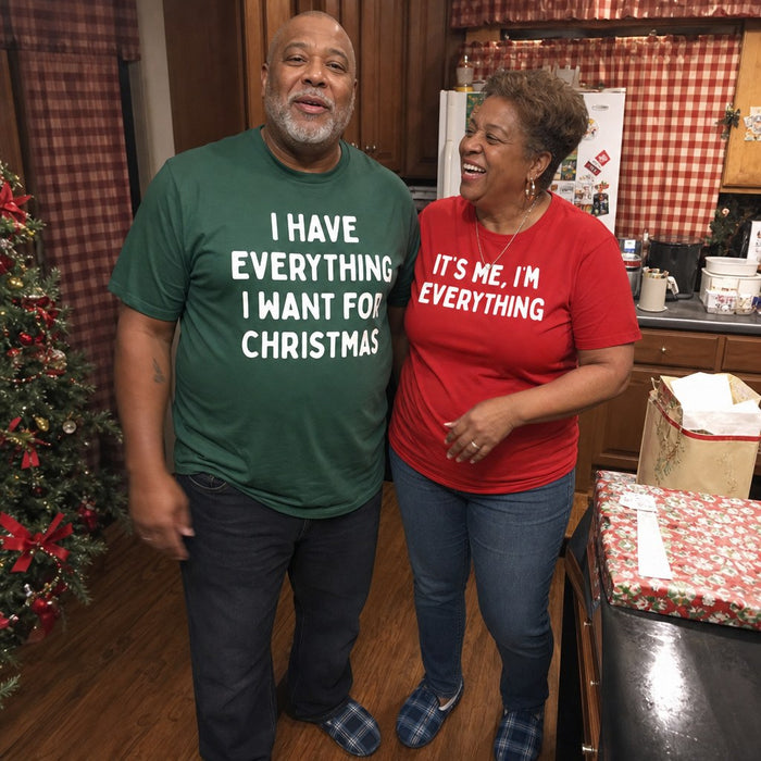 A couple in their kitchen laughing at the matching tees they are wearing