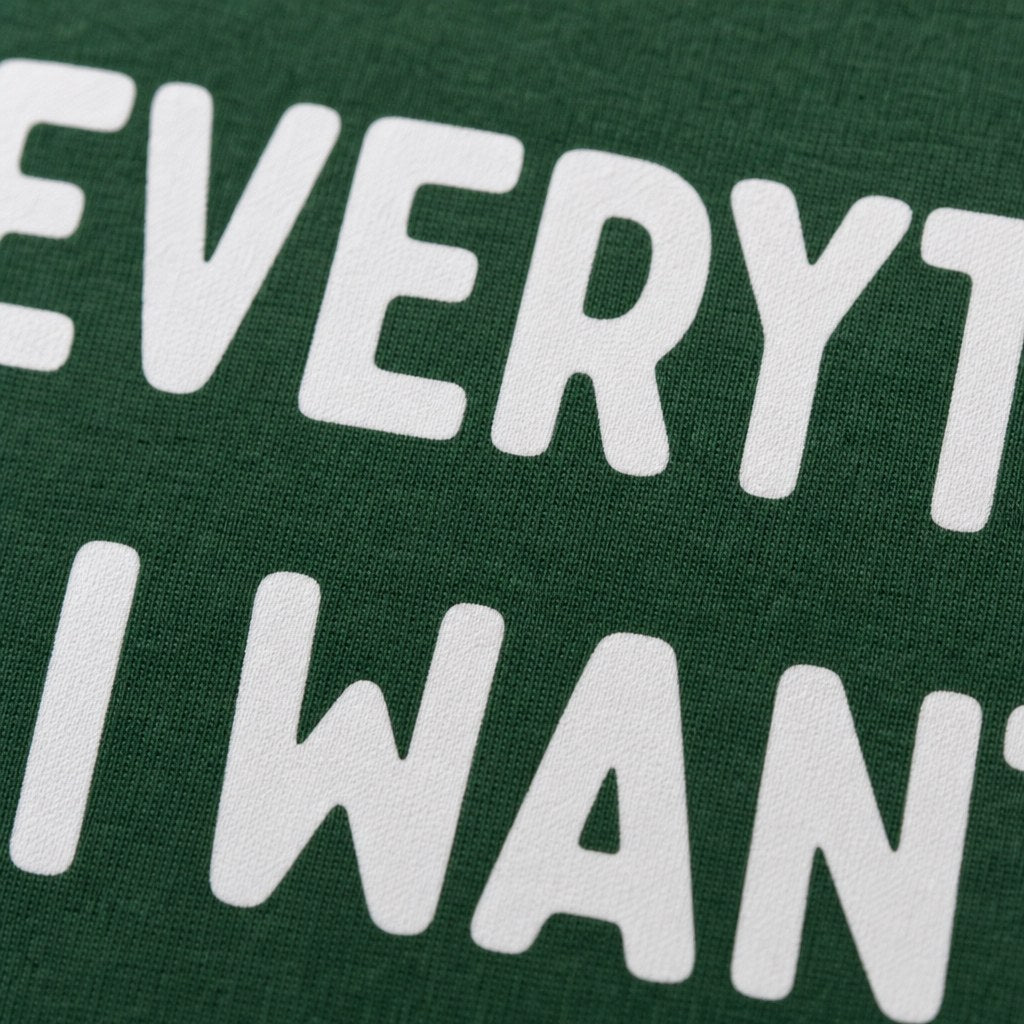 Close up of the white print on the green cotton tee